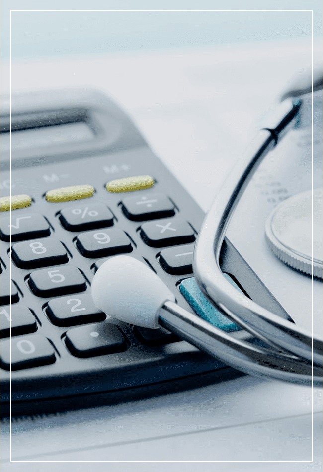 A calculator and stethoscope on top of a table.